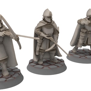 Puede incluir: Tres figuras en miniatura sin pintar de arqueros medievales que llevan armadura de malla y capas. Cada figura sostiene un arco y una flecha y está de pie sobre una base redonda.