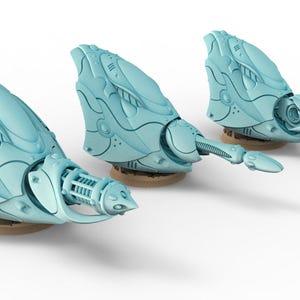 May include: Three light blue miniature sci-fi weapon turrets with intricate paneling and mechanical details. Each turret features a curved, aerodynamic housing mounted on a circular base, with a protruding barrel assembly extending forward.