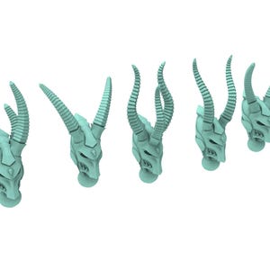 May include: Five light teal-colored, stylized skull sculptures with large, curved horns. Each skull has detailed facial features and rests on a small, round base. The horns are segmented, adding texture to the design. The skulls are arranged in a slightly staggered pattern.