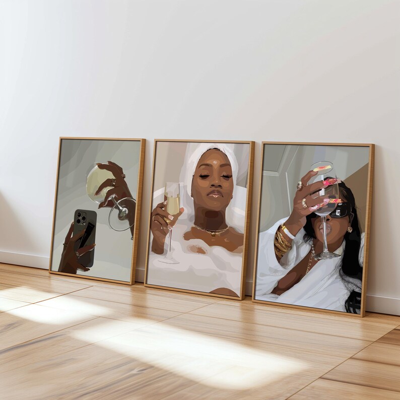 May include: Three framed art prints featuring illustrations of women enjoying champagne. One print shows a woman taking a selfie with a glass, another in a bathtub, and the third holding a glass with long nails.