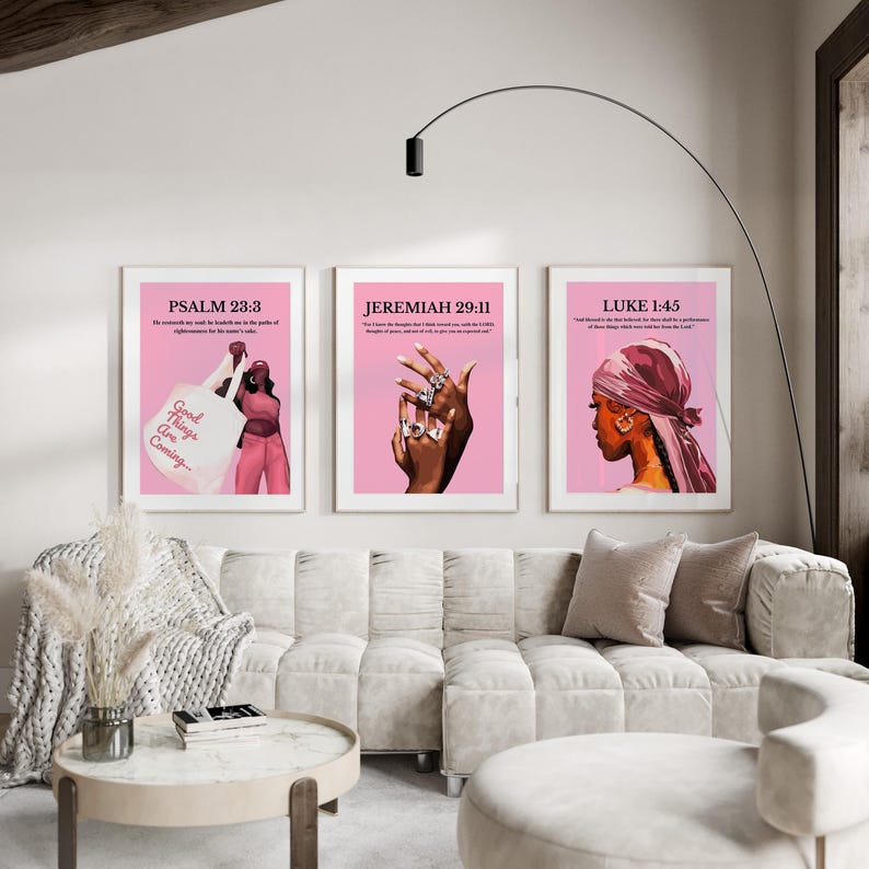 May include: Three framed art prints with pink backgrounds. The prints feature illustrations of a person, a hand with rings, and a profile of a person wearing a headscarf. Each print has a Bible verse and text. The first print says "Good Things Are Coming".