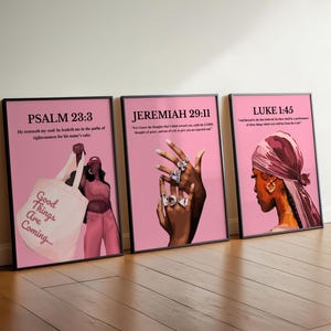 May include: Three framed art prints with pink backgrounds. The prints feature illustrations of women and text from the Bible. One print shows a woman holding a tote bag with the text "Good Things Are Coming...". The other prints show women wearing jewelry and headscarves.
