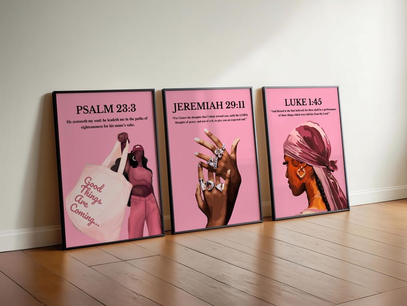 May include: Three framed art prints with pink backgrounds. The prints feature illustrations of women and text from the Bible. One print shows a woman holding a tote bag with the text "Good Things Are Coming...". The other prints show women wearing jewelry and headscarves.