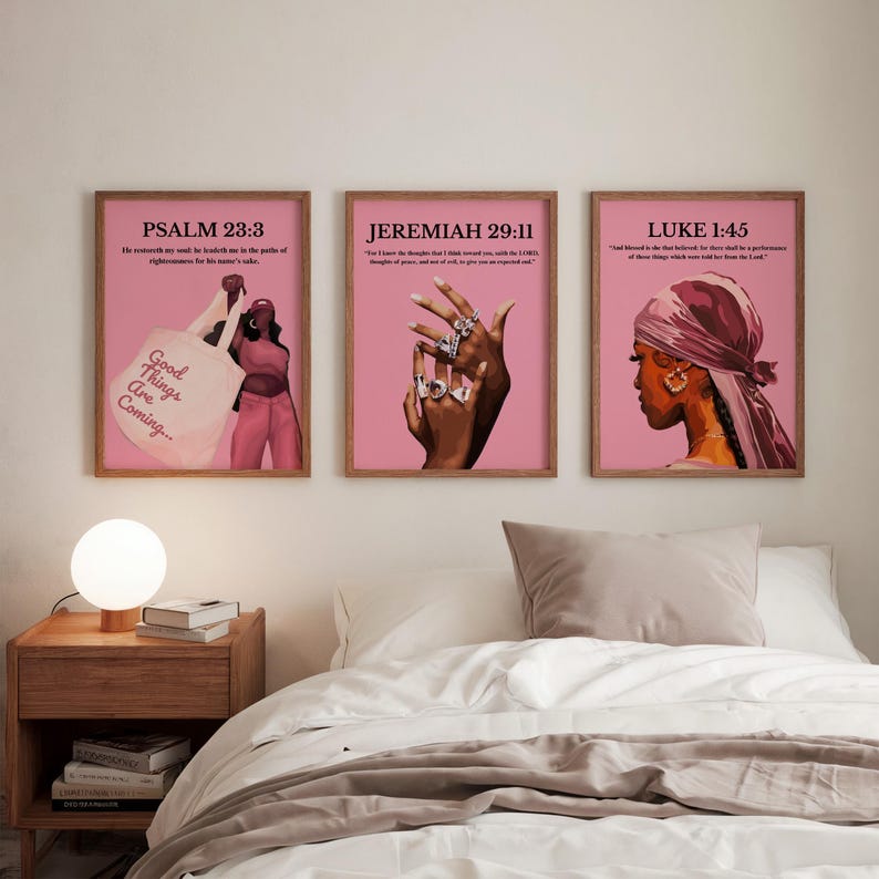 May include: Three framed art prints with pink backgrounds and wooden frames. The prints feature illustrations of people and hands with jewelry. Each print has a Bible verse and the text "Good Things Are Coming..." on one print.