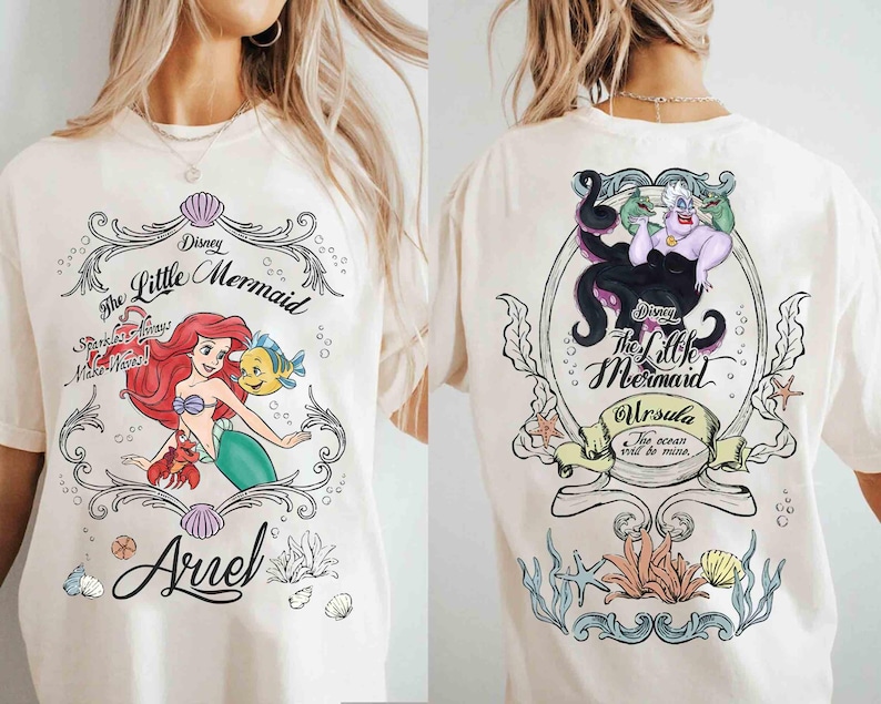 May include: Cream-coloured t-shirt featuring Disney's The Little Mermaid. The front graphic shows Ariel, Flounder, and Sebastian. The back graphic features Ursula. Text includes "The Little Mermaid", "Sparkle Always Make Waves!", and "Ursula The ocean will be mine."
