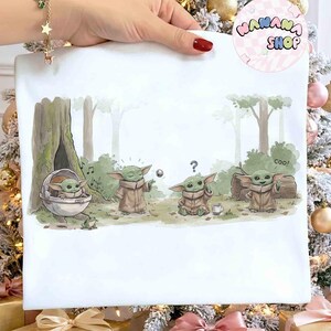 May include: White square canvas featuring a cartoon illustration of Grogu from The Mandalorian. The artwork depicts Grogu in various poses within a forest setting, with the word "Coo!" in a speech bubble. The background includes trees and foliage.