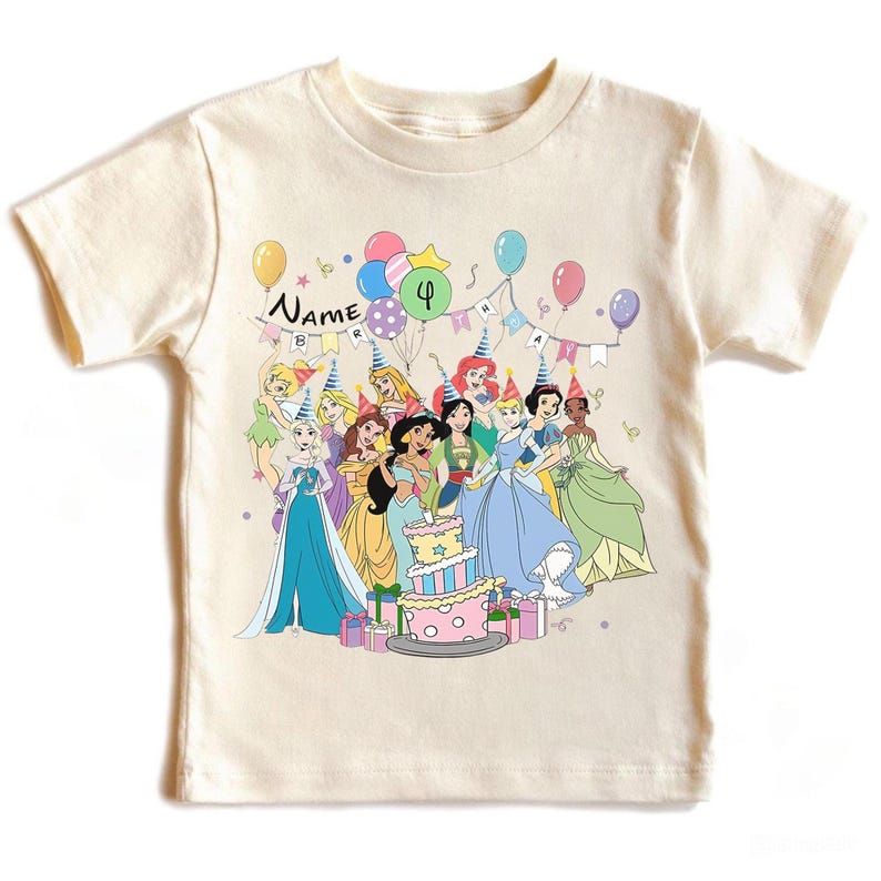 May include: Cream-colored t-shirt featuring a birthday party scene with cartoon princesses, balloons, and a cake. The shirt has the word "Name" and the number "4" on it. The princesses are wearing party hats.