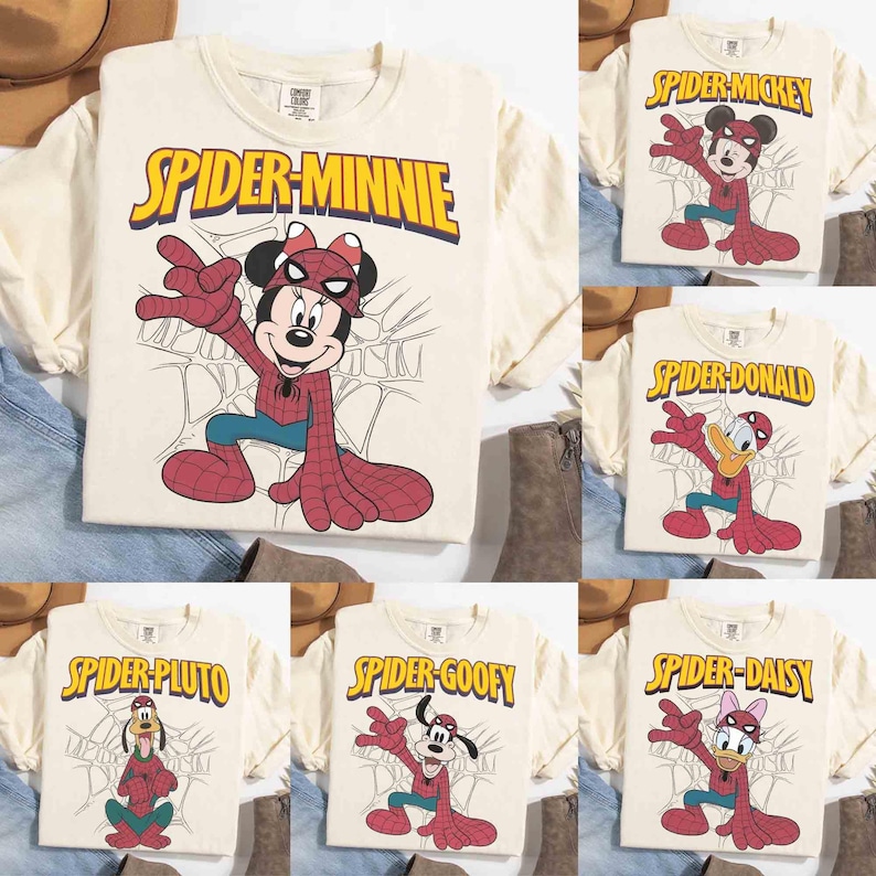 May include: Cream-colored t-shirts featuring various Disney characters in Spider-Man costumes. The shirts display characters like Minnie Mouse, Mickey Mouse, Donald Duck, Pluto, Goofy, and Daisy Duck, with the words "Spider" and the character's name in yellow.