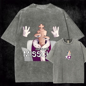 May include: A charcoal gray acid-wash t-shirt featuring a large graphic on the back of a chess king character wearing a purple robe with white fur trim, white gloves, and the text "ABSOLUTE MISSCL". A smaller version of the same graphic is on the front.