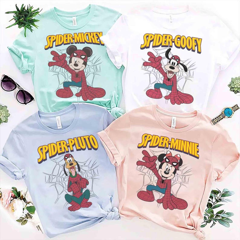 May include: Four colorful t-shirts featuring Disney characters as Spider-Man. The shirts are light blue, white, mint green, and pink. Each shirt has a different character: Mickey, Goofy, Pluto, and Minnie Mouse. The text "Spider" is in yellow.