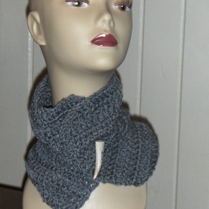 May include: A gray crocheted cowl with a white antler pendant.