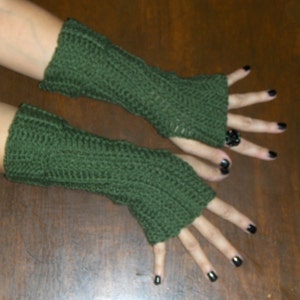 May include: A pair of green fingerless gloves made of crocheted yarn.