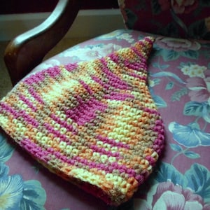 May include: A crocheted hat with stripes of pink, orange, yellow, and brown.