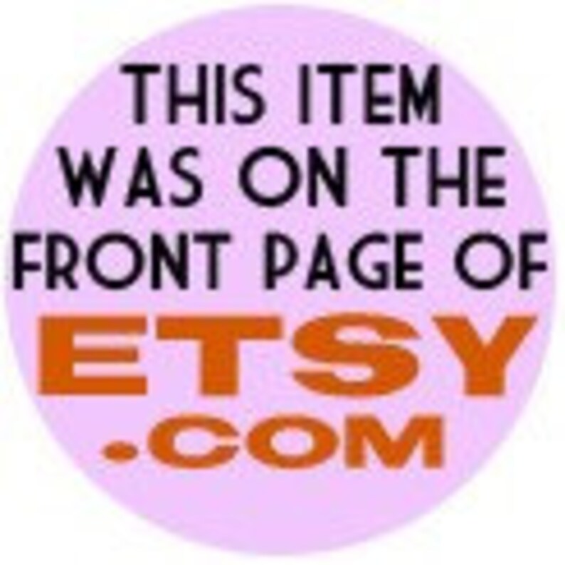 May include: A round, light purple sticker with black text that reads "THIS ITEM WAS ON THE FRONT PAGE OF ETSY.COM" in a bold, orange font. The sticker is likely used to promote an Etsy shop or product.