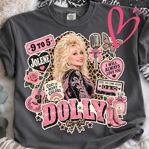 May include: A charcoal gray t-shirt featuring a graphic print of Dolly Parton surrounded by various icons including a microphone, a guitar, a cassette tape, a perfume bottle, cowboy boots, a butterfly, and text reading 9 to 5, Jolene, and Dolly.
