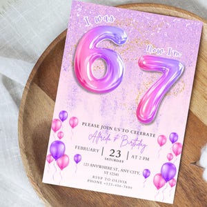 May include: A birthday invitation with a lavender and pink color scheme. The text "I was 67" is displayed with large, gradient-colored numbers. The invitation includes details for a birthday celebration, with balloons and gold glitter accents.