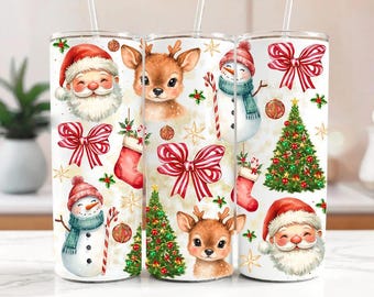 May include: Three white insulated tumblers with Christmas-themed designs. Each tumbler features a different festive illustration: Santa Claus, a reindeer, and a snowman, along with Christmas trees, bows, and stockings.