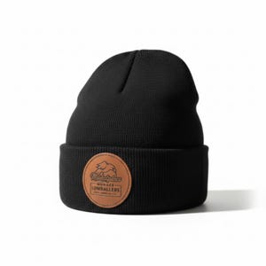 May include: A black knit beanie with a brown leather patch. The patch features the text "Marketplace - Menace Lowballers" in a circular design. The beanie is a classic style, suitable for cold weather.