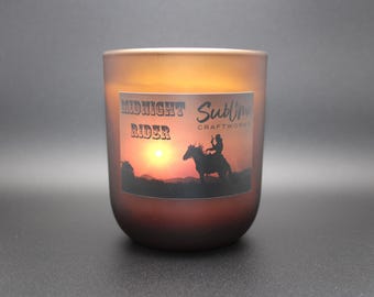 Scented Candle "Midnight Rider" starts with a crisp hit of camphor, softens into vanilla and patchouli, and settles oakmoss and musk.