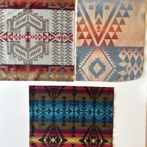 May include: Three square fabric swatches featuring intricate geometric patterns. The top left swatch displays gray, red, and orange motifs. The top right swatch shows blue, tan, and orange designs. The bottom swatch features a dark blue, red, and gold pattern.