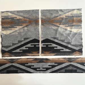 May include: Three pieces of fabric with a geometric pattern in shades of gray, brown, and black. The design features stepped shapes and horizontal bands. The fabric pieces are arranged on a white surface.