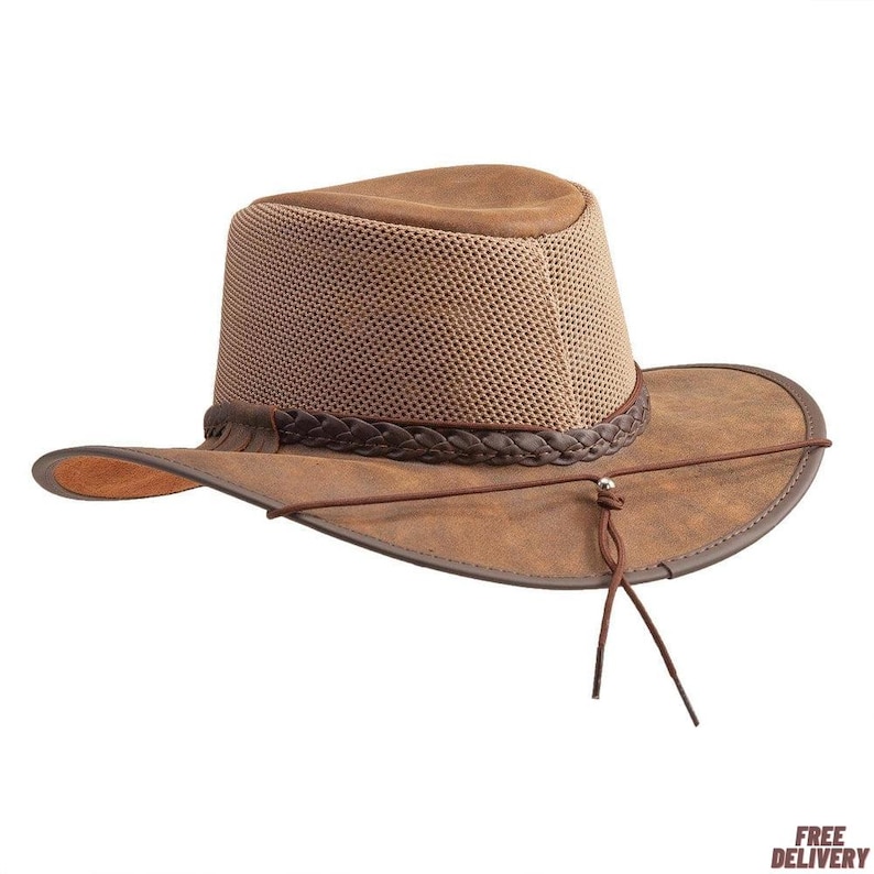 Pode incluir: Chap&eacute;u castanho com aba larga e copa em rede. O chap&eacute;u apresenta uma faixa tran&ccedil;ada e uma correia de queixo. A aba mede aproximadamente 7.6 cm de largura. Desenhado para atividades ao ar livre.