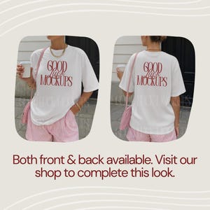 May include: A white t-shirt with the text "GOOD MOCKUPS" in red on the front and back. The model is wearing pink and white striped shorts and a pink shoulder bag. The image shows the front and back of the shirt.
