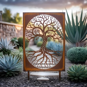May include: A rectangular, rusty-brown metal garden art piece featuring a cut-out tree design. The tree's branches and roots are intricately detailed within an oval frame. The art piece is supported by two metal posts and sits among various plants.
