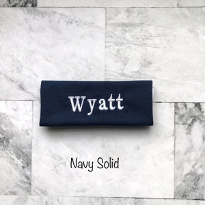 Personalized navy handle wrap, with white embroidery your choice of name or monogram. Our handle wraps measure  4.5 inches by 5.25 inches and are 100% cotton with a strip of Velcro to attach securely around any handle.