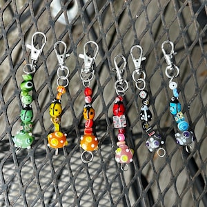 Handmade ladybug themed keychains, earrings, and phone charms : Glass beaded lady bug art.