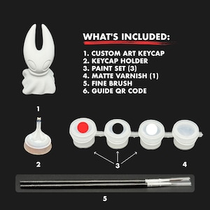 Pode incluir: Um conjunto de pintura com uma figura de keycap de arte personalizada branca, um suporte de keycap, um conjunto de tinta com três cores, verniz fosco e um pincel fino. O texto "WHAT'S INCLUDED" está no topo da imagem.
