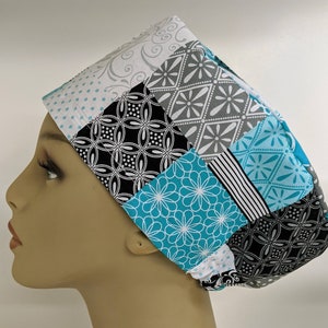 May include: A turquoise, black, white, and gray patterned scrub hat with a patchwork design.