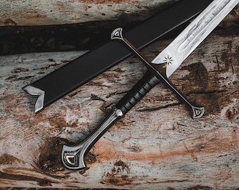 May include: A detailed image of a sword with a silver blade and a black handle. The sword features a star-shaped design on the blade and rests on a wooden surface. A black sheath is also present.