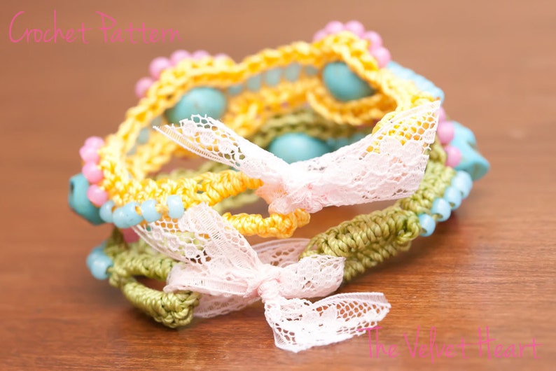 May include: A multi-layered crocheted bracelet with yellow, green, and pink yarn. The bracelet is decorated with blue and pink beads and white lace bows.