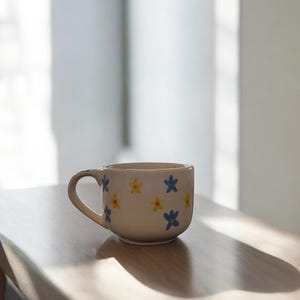 Oversized white ceramic mug with blue and yellow flowers