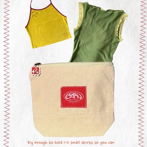 May include: A yellow halter top with star details and a green vest top are shown. A beige canvas bag with a red logo patch and zip contains the vest top. Text reads: "Big enough to hold 1-2 small shirts so you can take your projects on the go!"