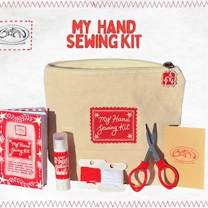 May include: A beige canvas "My Hand Sewing Kit" with red accents. The kit includes a zippered pouch, scissors, thread, glue stick, and a booklet. The text "My Hand Sewing Kit" is displayed on the pouch and booklet. The kit is surrounded by a red stitched border.