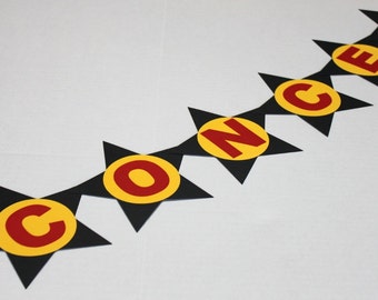 May include: A black and yellow star-shaped banner with the word "CONCESSIONS" spelled out in red letters.
