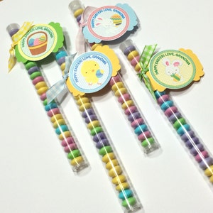 May include: Four clear plastic tubes filled with colorful candy. Each tube has a tag attached with a different Easter design and the text "Happy Easter Love, Grandma".