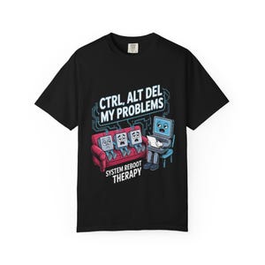May include: Black t-shirt with a humorous graphic. The design features three sad-faced keyboard keys on a red couch, with a computer therapist. Text reads "CTRL, ALT DEL MY PROBLEMS" and "SYSTEM REBOOT THERAPY."