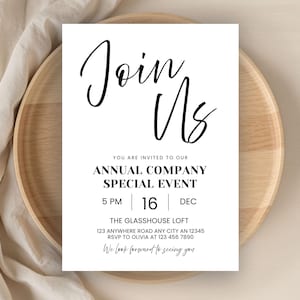 May include: A white invitation card with black text that reads "Join Us" in cursive script. The card announces an annual company special event, including the date, time, and location. The card is placed on a wooden tray.