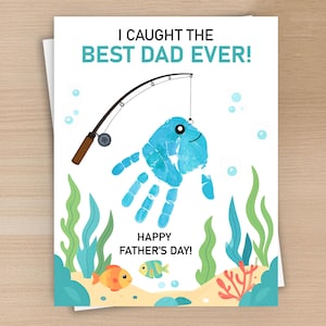May include: Father's Day card with the text "I Caught the Best Dad Ever!" and "Happy Father's Day!" A blue handprint fish is caught on a fishing rod. The card features an underwater scene with fish and seaweed.
