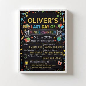 May include: A framed chalkboard-style print celebrating Oliver's last day of kindergarten. The colorful design includes text, a school bus, balloons, and stars. It lists Oliver's age, teacher, favorites, and what he learned.