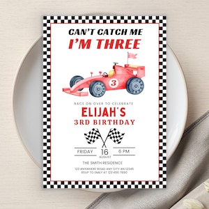 May include: A birthday invitation with a race car theme. The invitation features a red race car illustration and the text "CAN'T CATCH ME I'M THREE". It includes the name "Elijah" and the date and time of the party.
