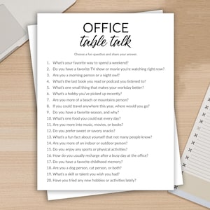 May include: A white sheet of paper with the text "OFFICE table talk" and a list of 20 questions. The questions are designed to spark conversation and are suitable for office icebreakers or team-building activities. A laptop and notepad are in the background.