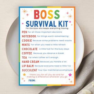 May include: A rectangular card titled BOSS SURVIVAL KIT in colourful letters, listing items like pen, notebook, cookie, mints, chocolate, coffee, tea, hand cream, lip balm, and succulent with descriptive text for each, ending with a FROM line.
