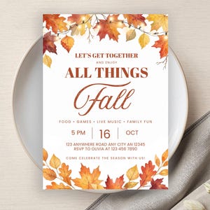 Puede incluir: Una tarjeta de invitación rectangular con hojas de otoño en acuarela y luces de cadena en la parte superior e inferior. El texto dice: LET'S GET TOGETHER AND ENJOY ALL THINGS Fall, FOOD GAMES LIVE MUSIC FAMILY FUN, 5 PM 16 OCT, 123 ANYWHERE.