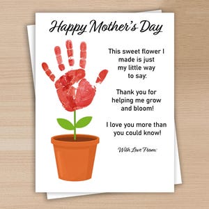 May include: A white Mother's Day card with a handprint flower design. The flower is made from a red handprint with green leaves and a brown pot. Text reads "Happy Mother's Day" and a message.