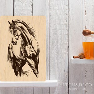 May include: A wooden sign featuring a detailed illustration of a running horse in shades of brown. The horse is depicted with flowing mane and muscular build. The sign is displayed on a white shelf against a white wooden background.
