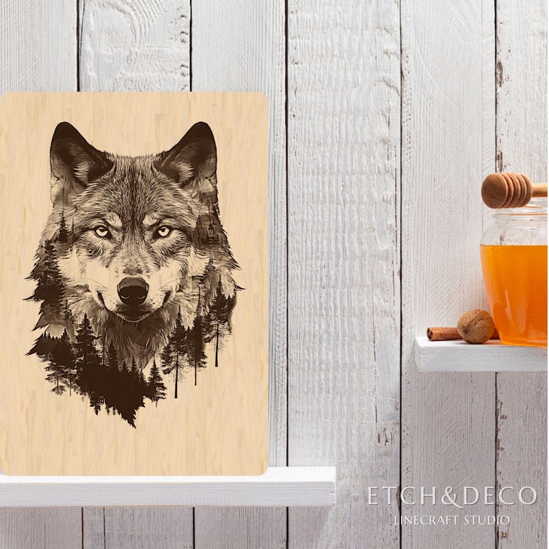 May include: A wooden wall art piece featuring a detailed illustration of a wolf's head with a forest incorporated into the design. The artwork is in shades of brown and black, with the text "ETCH&DECO" visible in the lower right corner.